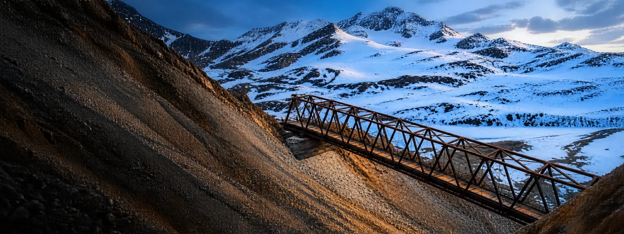 Steel truss bridge fabricated by Schuler Manufacturing spanning a remote gorge in Denali National Park