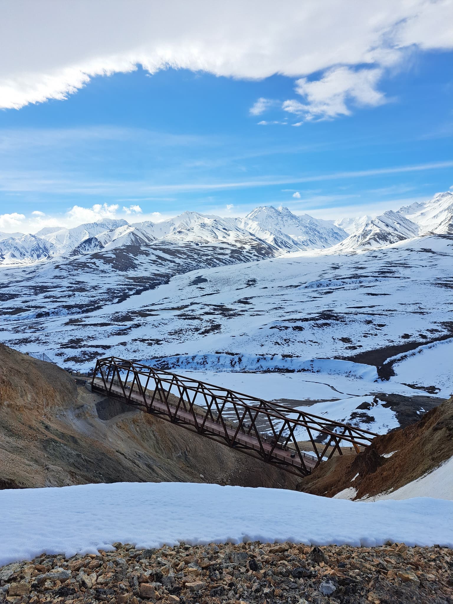 Steel truss bridge spanning a snow-covered gorge in Denali National Park