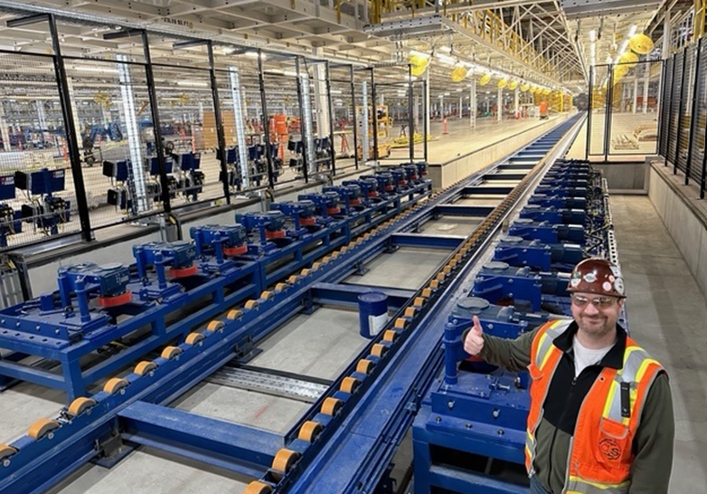 Blue automotive skillet conveyor track system on a production floor